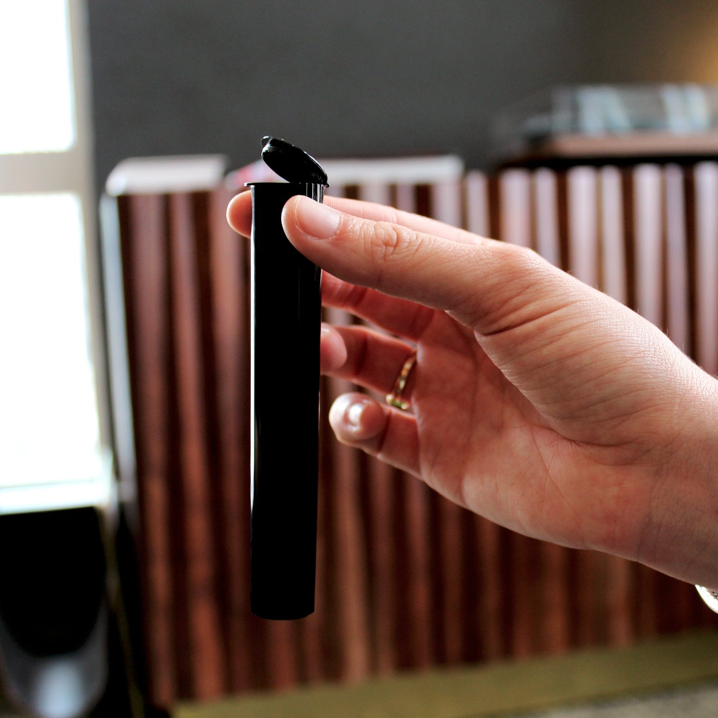 Child-Resistant Opaque Black 116mm GriploK Pre-Roll Tube Opened in Hand