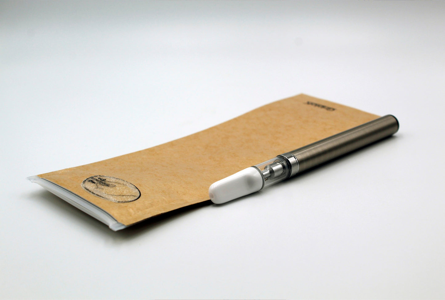 GriploK Opaque Kraft 2.5x7 Child Resistant Mylar Exit Bag & PureCore C-Core 0.5ml Cartridge with White Ceramic Mouth Piece on Auto-Pull Battery in Silver