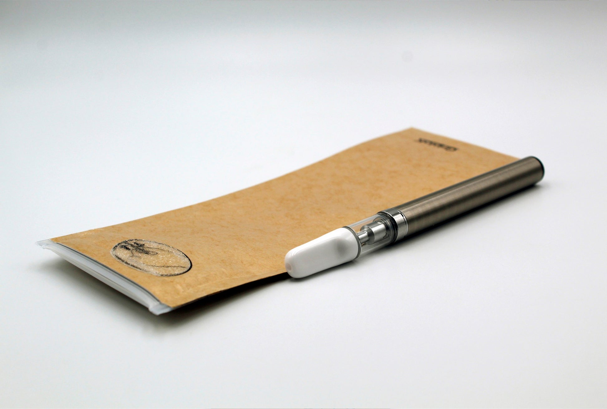 GriploK Opaque Kraft 2.5x7 Child Resistant Mylar Exit Bag & PureCore C-Core 0.5ml Cartridge with White Ceramic Mouth Piece on Auto-Pull Battery in Silver